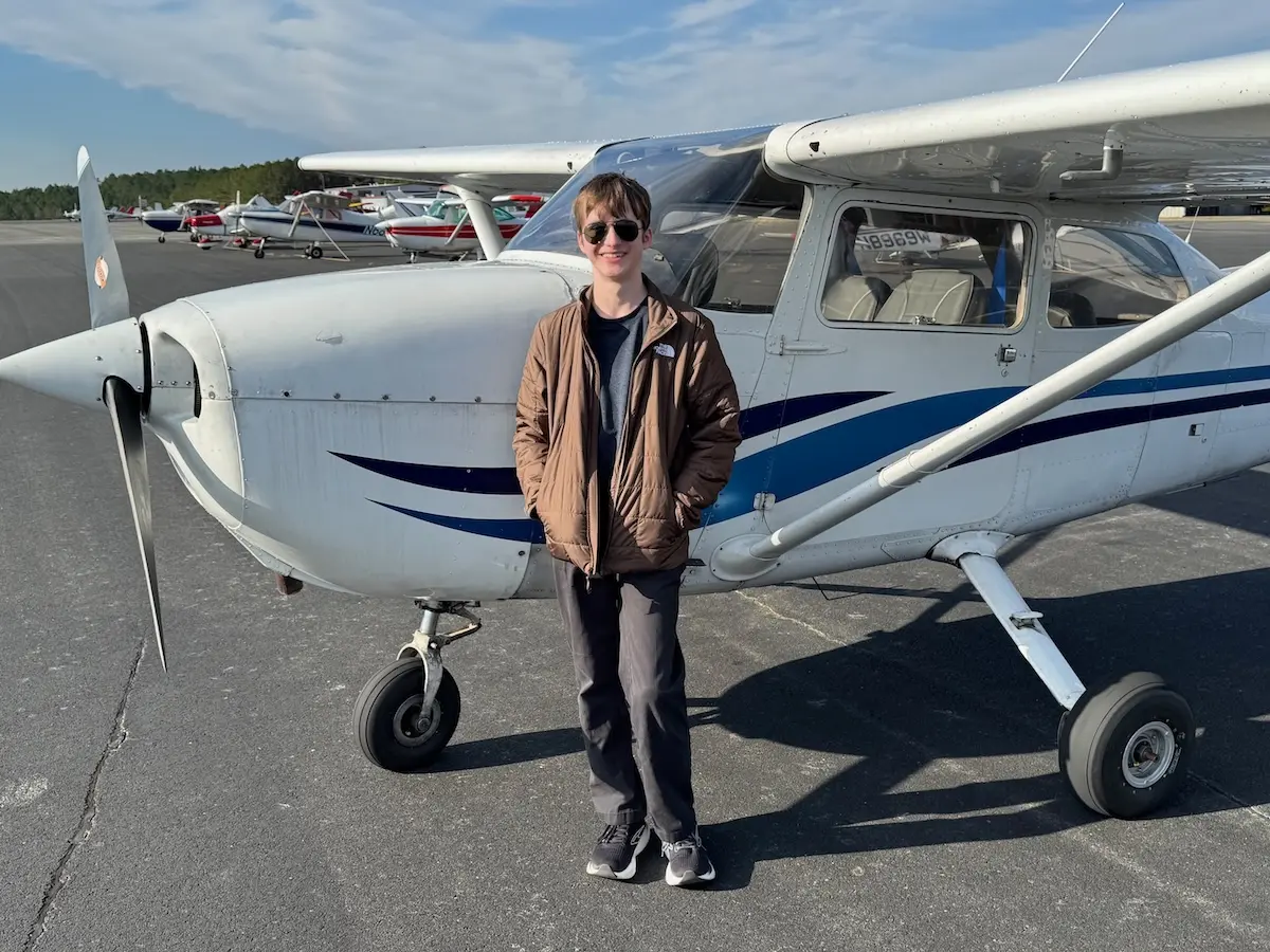 Nicholas outside the plane he just completed his first solo in